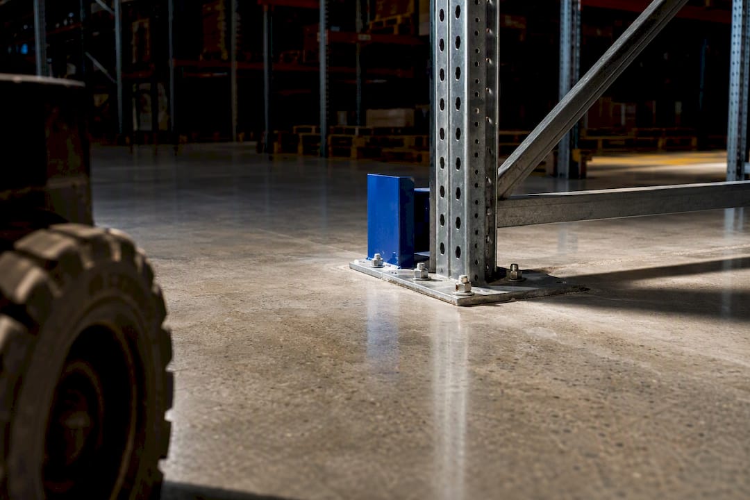 Warehouse racking base plate on concrete floor