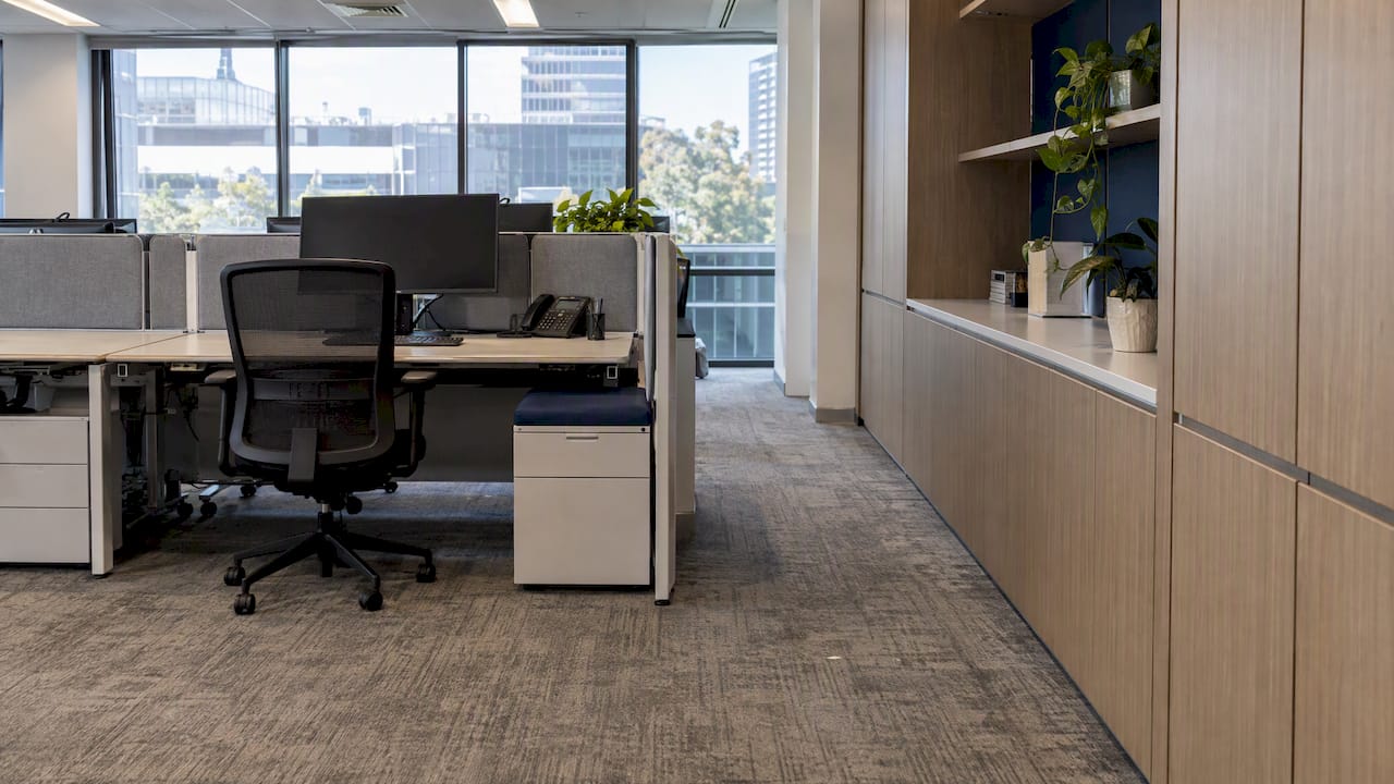 Modular workstations beside fixed office joinery