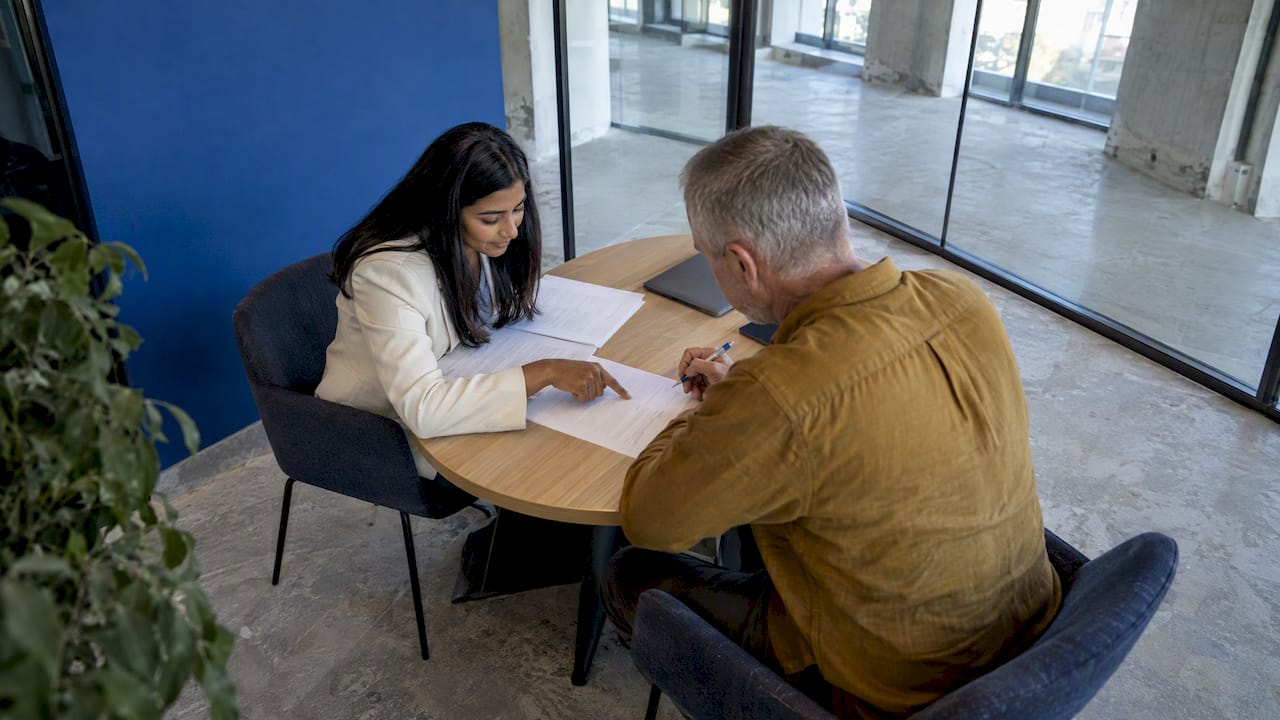 Prospective tenants review lease before signing