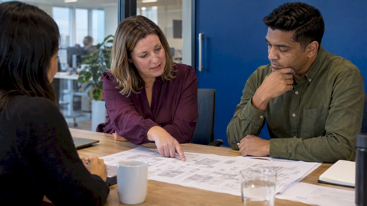 Staff reviewing an office plan together