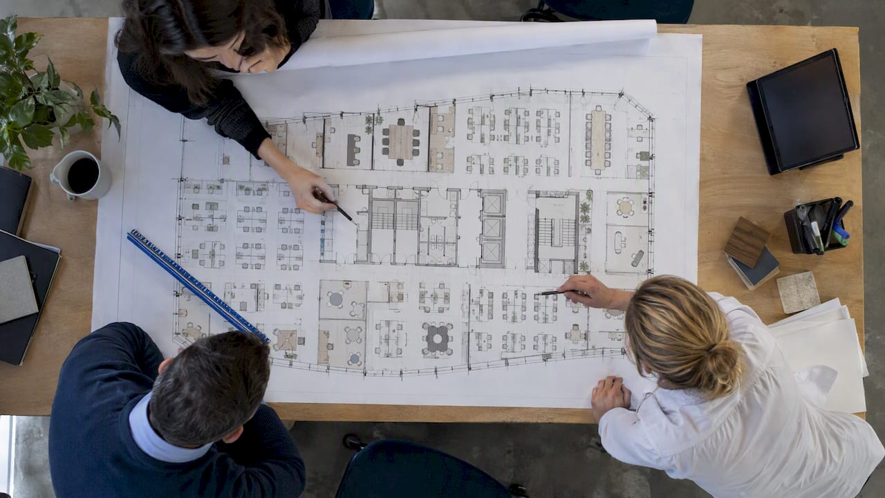 Scaled office test-fit plan on drafting table